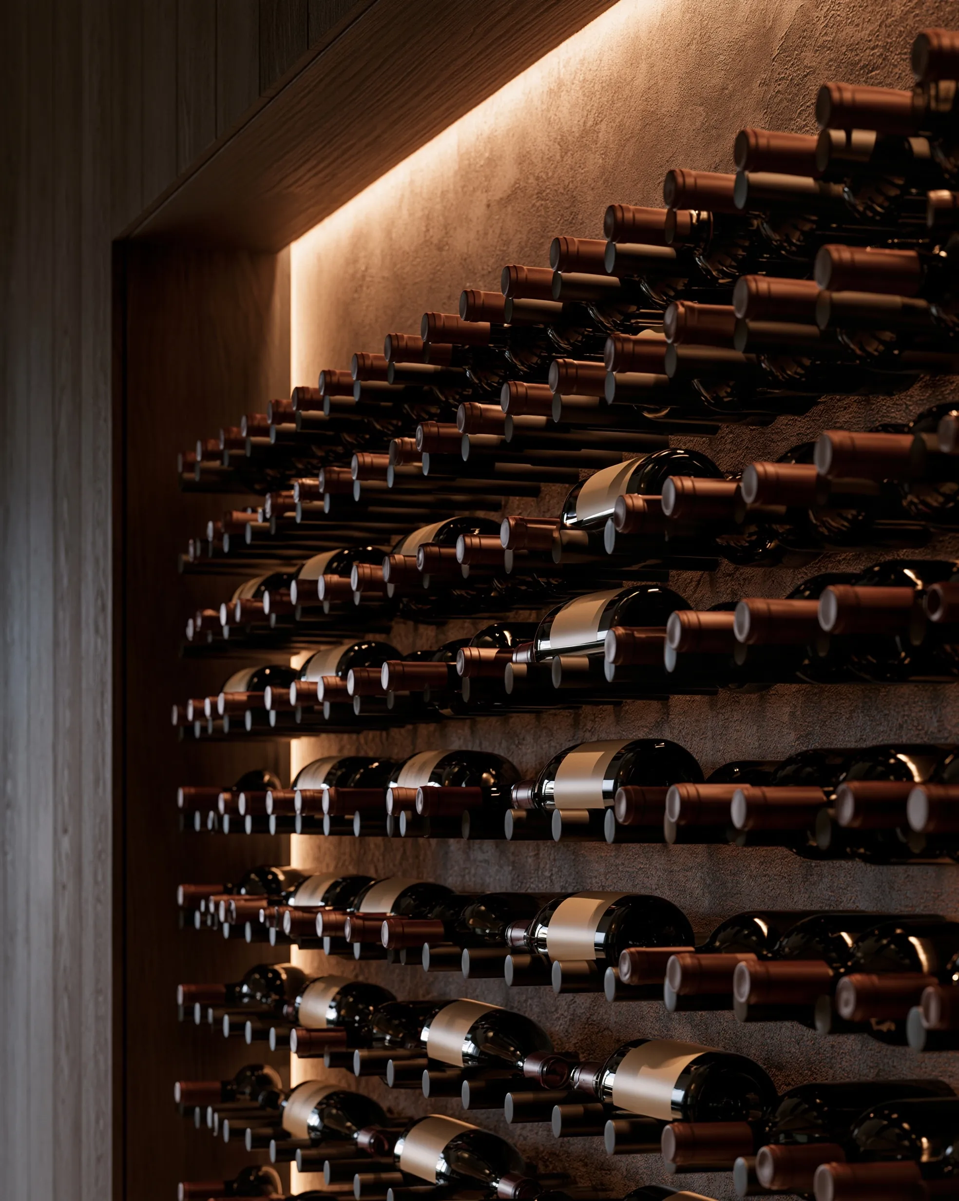 Bottles held on black metal pegs against a textured plaster wall, washed by a concealed LED strip
